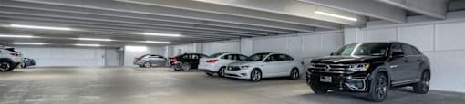 A parking garage with several cars parked inside.