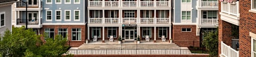 A row of apartment buildings with balconies and doors at The Port at East Beach Apartments and Marina in Norfolk, Virginia