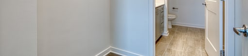 an empty bathroom with a closet and a toilet at The Port at East Beach Apartments and Marina, Virginia, 23518