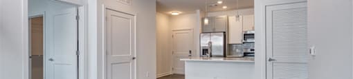 an empty living room and kitchen with a ceiling fan at The Port at East Beach Apartments and Marina, Norkfolk, 23518