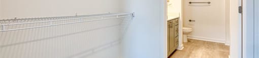 a white bathroom with a toilet and a closet at The Port at East Beach Apartments and Marina, Norkfolk, VA, 23518