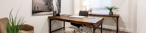 a home office with a desk and a window