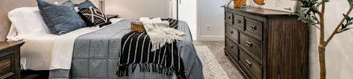 a bedroom with a bed and a dresser