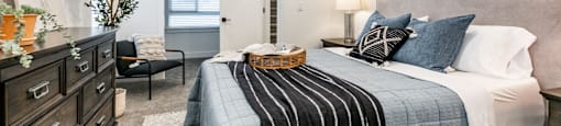 a bedroom with a bed and a dresser