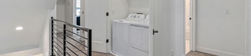 a hallway with a laundry closet with washer and dryer