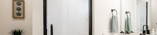 a bathroom with a shower and a sink and a toilet