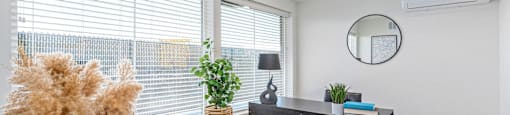 an office with a large window and a desk with a chair
