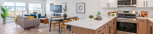 a living room with a kitchen and a dining room