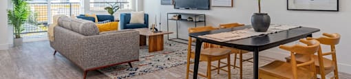 a living room and dining room with a table and chairs