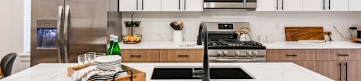 a kitchen with white cabinets and a white counter top