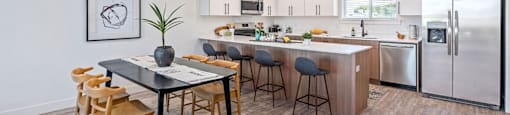 an open kitchen and dining area with a table and chairs