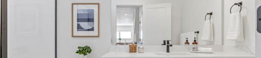 a white bathroom with a toilet and a sink