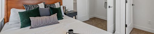 a bedroom with a bed and a painting on the wall