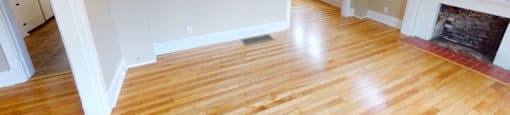 A room with wooden floors and a fireplace.
