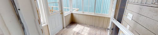 A room with a window and a door is shown.