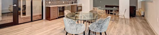 A conference room with a glass table and chairs.