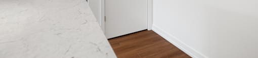 A kitchen with a refrigerator, oven, and microwave.