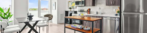 A modern kitchen with a dining table and chairs.