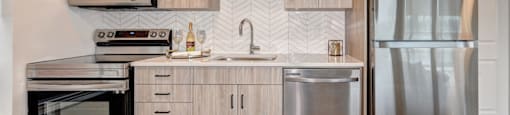 A modern kitchen with wooden cabinets and stainless steel appliances.