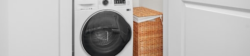 A white washing machine and dryer in a small laundry room.