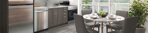 A modern kitchen with a dining table set for four.