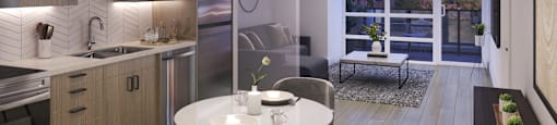 A modern kitchen with a dining table set for two.