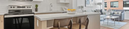 A modern kitchen with white cabinets and a large island.