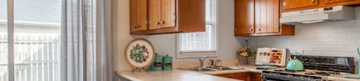 Model unit kitchen with an island and two stools.