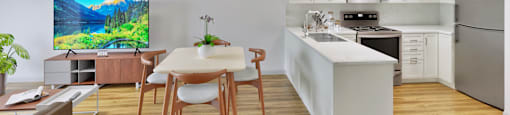 A modern kitchen with a dining table and chairs.
