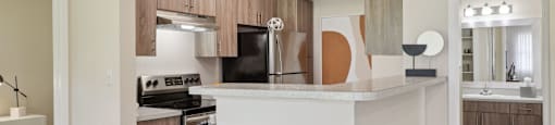 A kitchen with a white island and wooden cabinets.