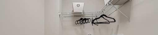 A small closet with a shelf and a bench.
