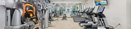 A gym with treadmills and exercise equipment.