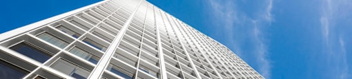 A tall building with a blue sky in the background.