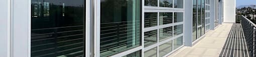 A long corridor with glass windows and doors.