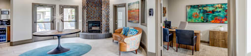 A large room with a blue rug and a fireplace.