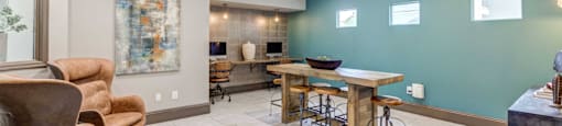 A modern dining room with a wooden table and chairs.