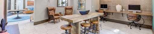 A modern kitchen with a bar area and a dining table.