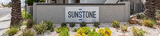 A house with a sign that says Sunstone in front of it.