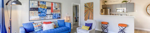 A living room with a blue couch and a coffee table.