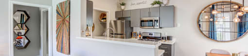 A kitchen with a bar stool and a counter.