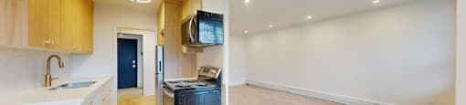 A kitchen with wooden cabinets and a black fridge.