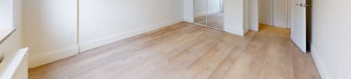 A room with wooden floors and white walls.