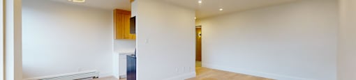 A room with wooden floors and white walls.