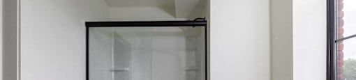 A white room with a glass door.