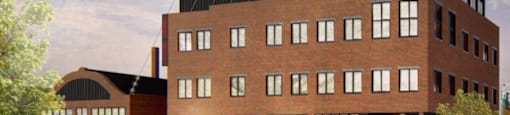 A modern building with a green roof is depicted in the image.