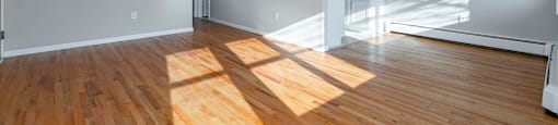 A room with wooden floors and white walls.