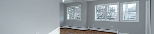 A room with wooden floors and white walls.