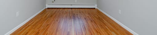 A room with a wooden floor and a window.