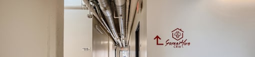 A hallway with a logo on the wall that says "GameHive".