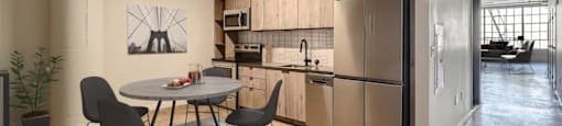 A modern kitchen with a dining table and chairs.